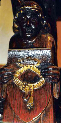 Angel holding a wooden shield on which is engraved the belt of truth