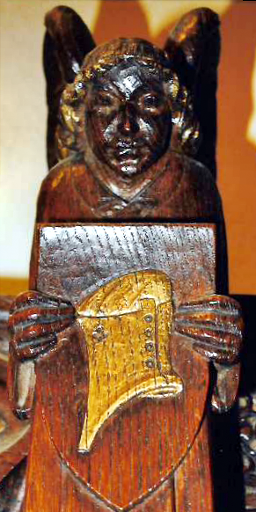 Angel holding a wooden shield on which is engraved the helmet of salvation