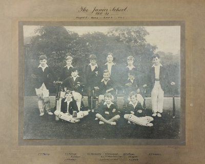 Formal photograph showing six players standing behind three seated players with three players sitting cross-legged in front of them