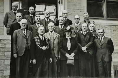 Three rows of people standing on the steps to the new extensions