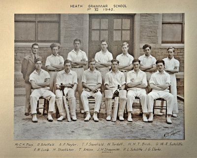 Formal photograph showing thirteen players in two rows of seven standing and six sitting with Mr Place to the left of the back row