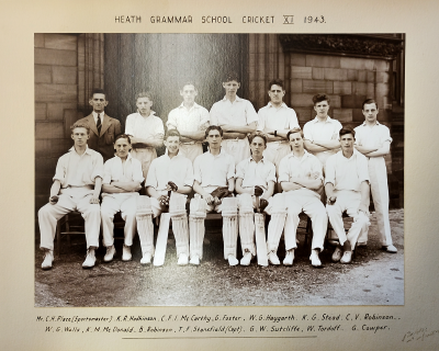 Formal photograph showing thirteen players in two rows of six standing and seven sitting with Mr Place to the left of the back row