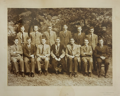 Six prefects standing behind six seated prefects with Mr Swale seated in the middle