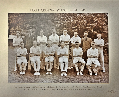Formal photograph showing thirteen players in two rows of eight standing and six sitting with Mr Place second from the right in the back row