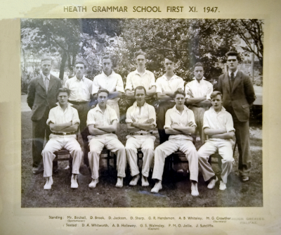 Formal photograph showing ten players in two rows, with five standing behind five seated and flanked by the Sportsmaster to the left and the Secretary to the right of the back row