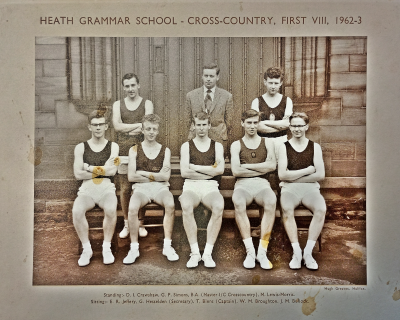 Formal photograph showing two team members with Mr G.P. Simons between them standing behind five seated team members