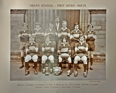 Formal photograph showing six team members standing on the front steps with Mr Bellerby standing behind them and four seated in front of them