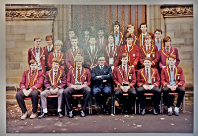 Two rows of boys standing behind one row of boys seated with Mr Crosby in the middle of the seated row