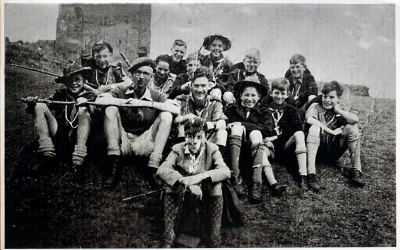 Group of scouts sitting at four levels on a slope