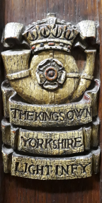 Rose within a ram’s horn surmounted by a crown with the name underneath