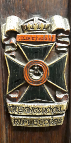 Maltese cross surmounted by motto ‘Celer et audax’ and crown with the name underneath with the name underneath