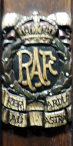 RAF surrounded by laurel wreath and surmounted by a crown with ‘Per ardua ad astra’ underneath