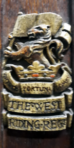 Lion holding a flag above a crown below which is ‘Virtutis Fortuna Comes’ and the name