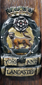 Lion surrounded by a laurel wreath surmounted by a rose and a crown with the name underneath