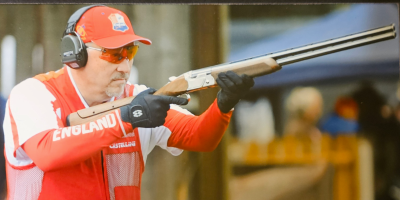 Jim Farrell aiming a gun to the right