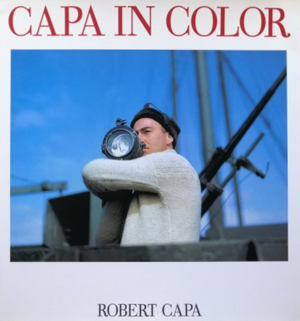 Bruce Marsh standing on a ship holding a signalling lamp