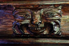 A carving of a laughing face whose eyes are wide open
