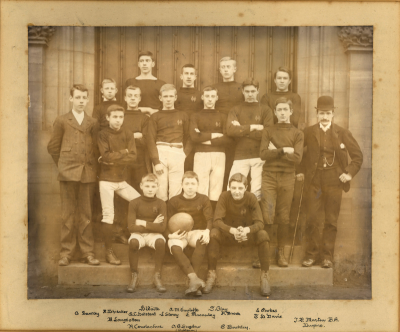 Formal photograph showing fifteen players in four rows with J.P. Martin BA to the right
