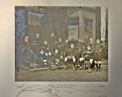 Formal photograph showing Mr Jennings and two players standing on the right behind five standing players with Mr Martin to the left and in front of whom are four variously seated