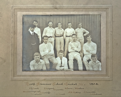 Formal photograph showing five players standing behind three seated players with Mr Jennings on the right and in front of whom are three players seated on the ground