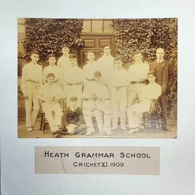 Formal photograph showing eight players and a master standing behind three seated players with the scorer seated cross-legged on the ground