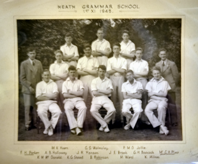 Formal photograph showing twelve players in three rows of three, four and five from back to front with the scorer and a teacher at each end of the middle row