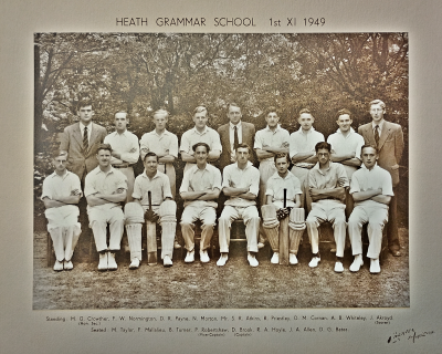 Formal photograph showing nine people standing and eight sitting