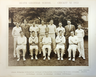 Formal photograph showing eight people standing and five sitting