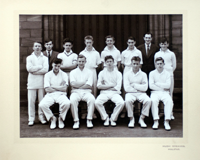 Formal photograph showing eleven players, the scorer and Mr Carter in one row of five seated and eight standing behind them