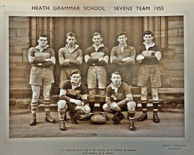 Five players standing behind two crouching
