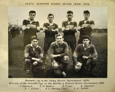 Three players stooping in front of four standing