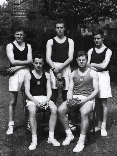 Formal photograph showing two seated and three standing