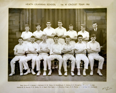 Formal photograph showing thirteen players. six standing and seven sitting, with Mr Hunter standing on the right of the back row