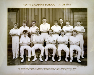 Formal photograph showing thirteen players. six standing and seven sitting, with Mr Hunter standing on the right of the back row
