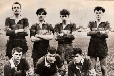 Four players standing behind three crouching