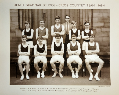 Formal photograph showing Mr Hardill standing behind five standing team members behind five seated team members