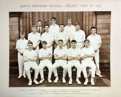 Formal photograph showing Mr Hunter and two players behind six standing players behind five seated players