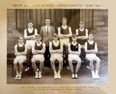 Formal photograph showing three team members and Mr A. Hardill standing behind five seated team members