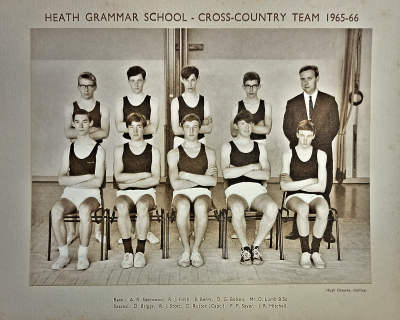 Formal photograph showing four team members and Mr D. Lumb standing behind five seated team members