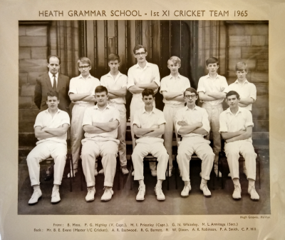 Formal photograph showing thirteen players. six standing and seven sitting, with Mr Evans standing on the right of the back row
