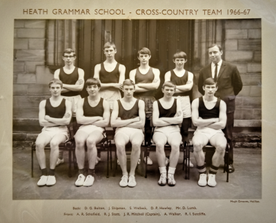 Formal photograph showing four team members and Mr D. Lumb standing behind five seated team members
