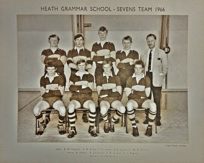 Formal photograph showing four players standing with Mr Birchall to their right behind four seated players