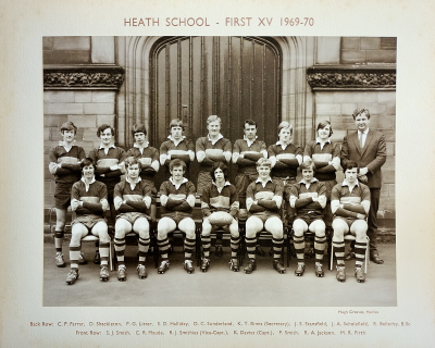 Formal photograph showing eight team members standing with Mr Bellerby on their right standing behind seven seated team members