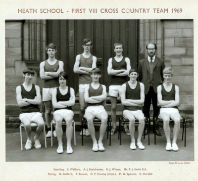 Formal photograph showing three team members and Mr P.J. Smith standing behind five seated team members