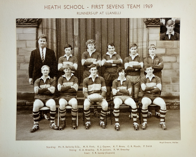 Formal photograph showing five team members standing on the front steps with Mr Bellerby to the left of the row behind five seated team members