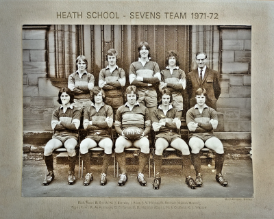 Formal photograph showing four team members with Mr Birchall to the right behind five seated team members