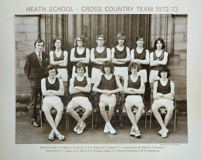 Formal photograph showing Mr Keenan and six team members standing behind five seated team members
