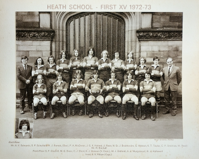 Formal photograph showing ten players flanked by Mr A.V. Edwards on the left and Mr Birchall on the right standing behind seven seated players with an inset of the captain