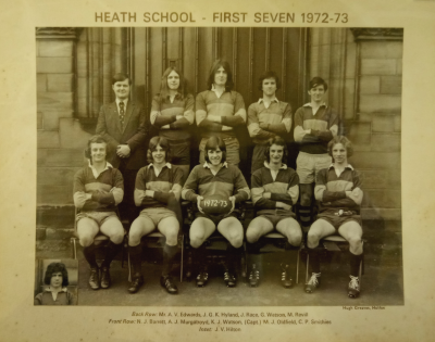 Formal photograph showing Mr A.V. Edwards and four team members standing behind five seated team members with an inset of J.V. Hilton