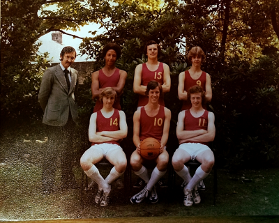Informal photograph showing three players with Mr Stansfield on their left standing behind three seated players